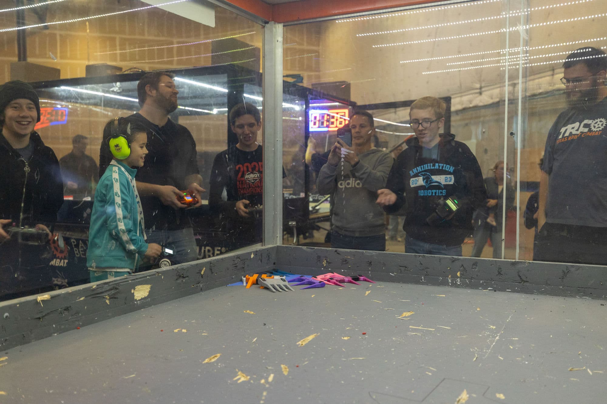 Spectators watching a combat robotics match at a local tournament